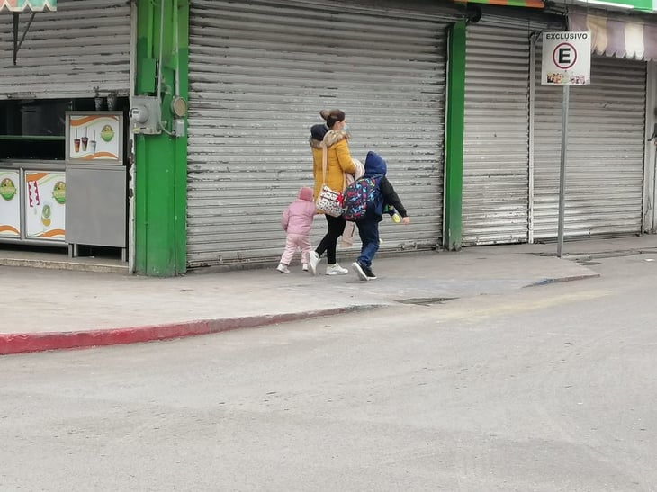 Familia desafían el frío y pasean por la zona comercial de Monclova